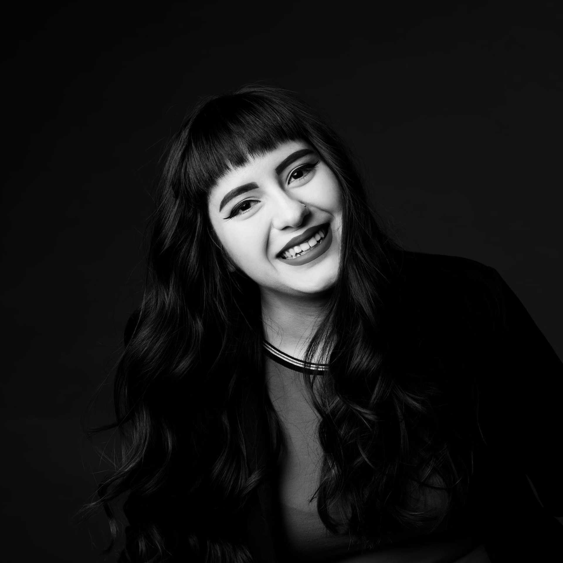 Portrait of Lorena, a professional stylist at Maxine Salon, showcasing their expertise and style.