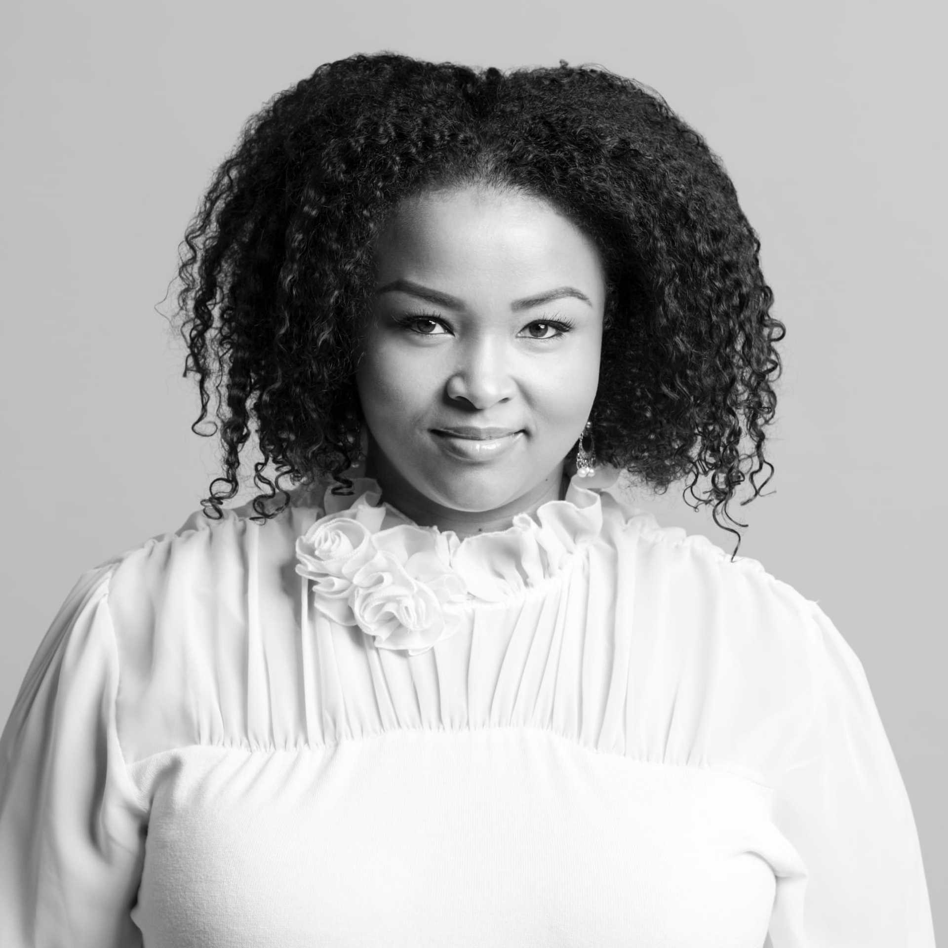 Portrait of Michelle, a professional stylist at Maxine Salon, showcasing their expertise and style.
